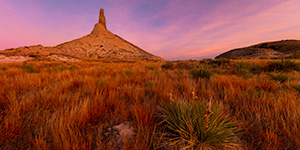 A scenic panoramic landscape Nebraska photograph of a sunset and Chimney Rock in western Nebraska. - Nebraska Photograph