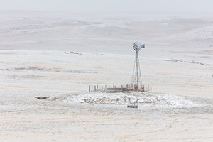 Scenic landscape panoramic photograph of a windmill in the winter at Oglala National Grasslands. - Nebraska Photograph