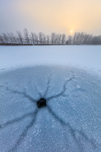 A scenic landscape photograph of fog over a frozen lake with the sunrise at Walnut Creek, Nebraska. - Nebraska Photograph