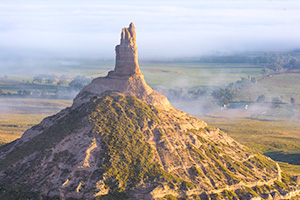 Morning Fog surrounds Chimney Rock in western Nebraska at sunrise. - Nebraska Photograph