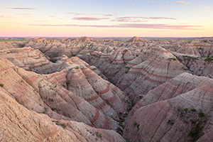 Dusk comes to Badlands National Park and the landscape is bathed in pastel hues. - South Dakota Photograph