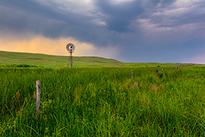 A Nebraska landscape scenic photograph of a windmill during a storm in the Sandhills of Nebraska. - Nebraska Photograph