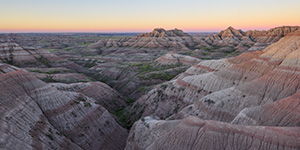 A panoramic scenic photograph of the sunrise over the Badlands National Park, South Dakota. - South Dakota Photograph