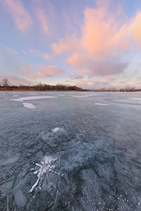 On a frigid January day clouds hover over the frozen Wehrspann Lake at Chalco Hills Recreation Area in Sarpy County, Nebraska. - Nebraska Photograph