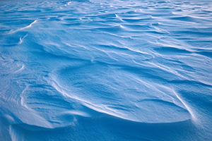 Snow drifts across Wehrspann Lake at Chalco Hills Recreation Area on a frigid February day. - Nebraska Photograph