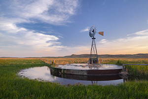 On a breezy evening in Crescent Lake National Wildlife Refuge a windmill stands like a sentinel among the sandhills. - Nebraska Nature Photograph