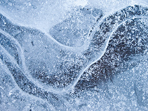 Bubbles and lines form an abstract pattern in the frozen ice in Stone Creek at Platte River State Park. - Nebraska Photograph