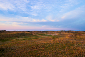 The last light of Day illuminates a windmill nestled in the sandhills on the western edge of Halsey National Forest. - Nebraska Photograph