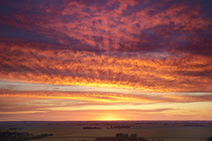 A beautiful sunrise crests over the distant farmland from the scenic overlook at Ponca State Park in Dixon County. - Nebraska Photograph