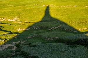 Chimney Rock's shadows stretches out across the plains as the sun dips low in the western sky. - Nebraska Photograph