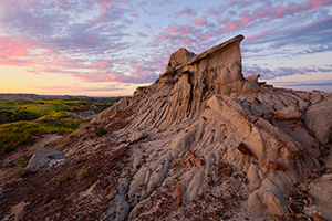 Clouds reflect the light of the rising sun across the High Plains in Theodore Roosevelt National Park. - North Dakota Photograph