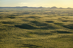 To the west of Chimney Rock the sky glows warm with the light of the setting sun. - Nebraska Photograph