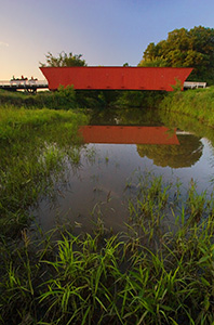 3 riders cross Hogback bridge in Iowa one of the famous bridges of Madison County. - Iowa Photograph