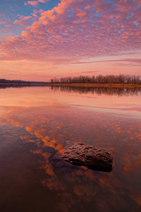 With nary a breeze and no other soul in sight, I enjoyed the vibrant colors brought forth from this sunrise in a quiet peacefulness and solitude. - Nebraska Photograph