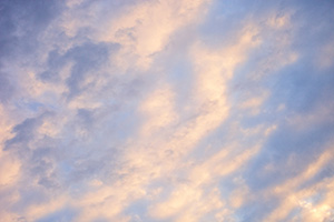 Light from the setting sun illuminates clouds in an abstract pattern on a chilly February evening. - Nebraska Nature Photograph