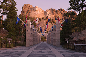 Mt. Rushmore National Monument at sunrise with the Avenue of Flags in the Black Hills of South Dakota. - South Dakota Photograph