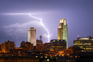 While setting up to capture the 9/11 tribute in downtown Omaha I instead witnessed a spectacular fall storm.  I managed to capture this lightning between the Woodmen Tower and the First National Bank Tower. - Nebraska Photograph