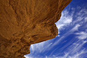 Clouds float lazily over the strange stone structures at Toadstool Geologic Park. - Nebraska Photograph