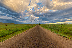 A scenic landscape photograph of a road deep in the sandhills of Nebraska. - Nebraska Photograph