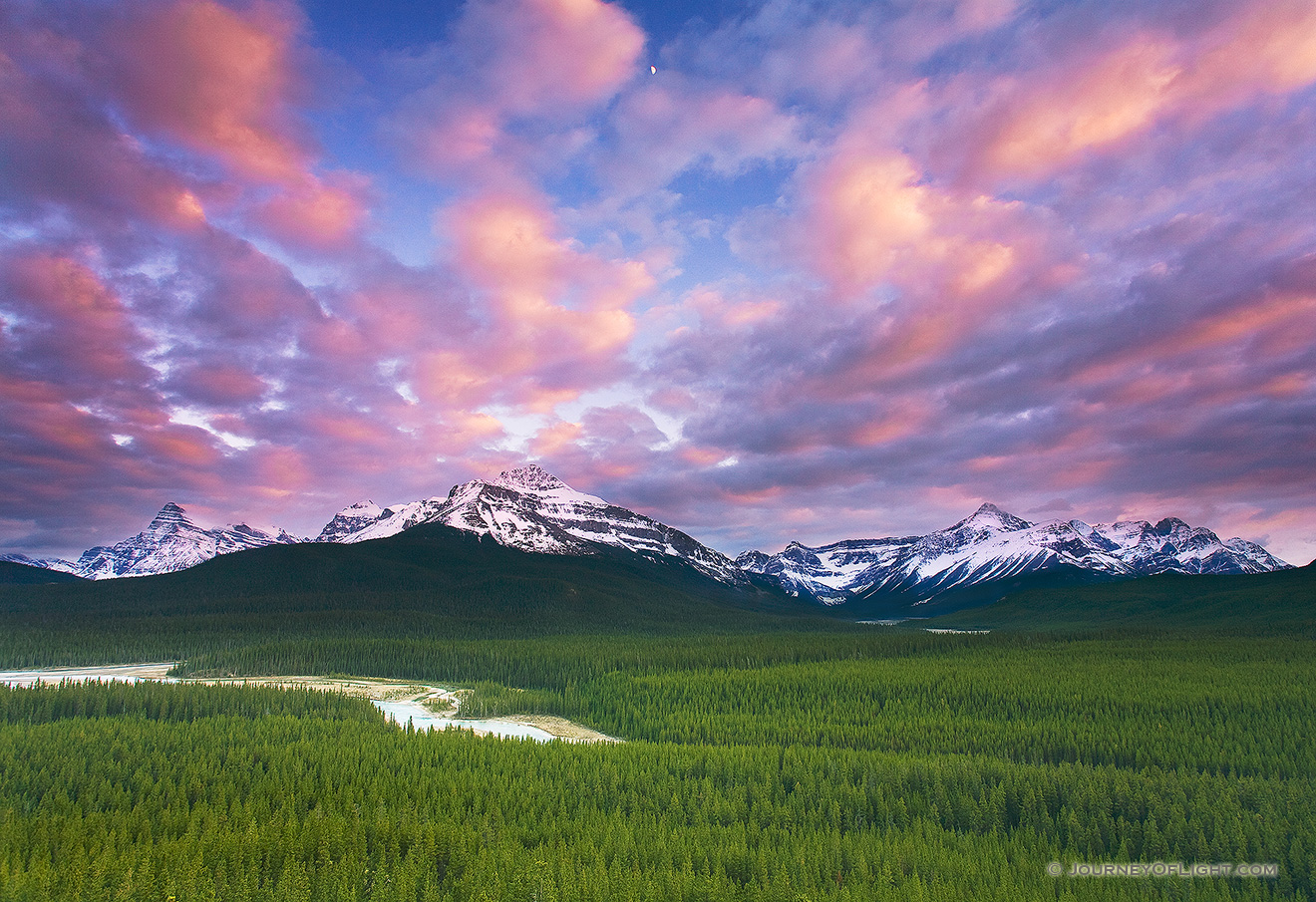 From a steep hill on the trail to Glacier Lake in Banff National Park, I could see the moon rise over the distant peaks. - Banff Picture