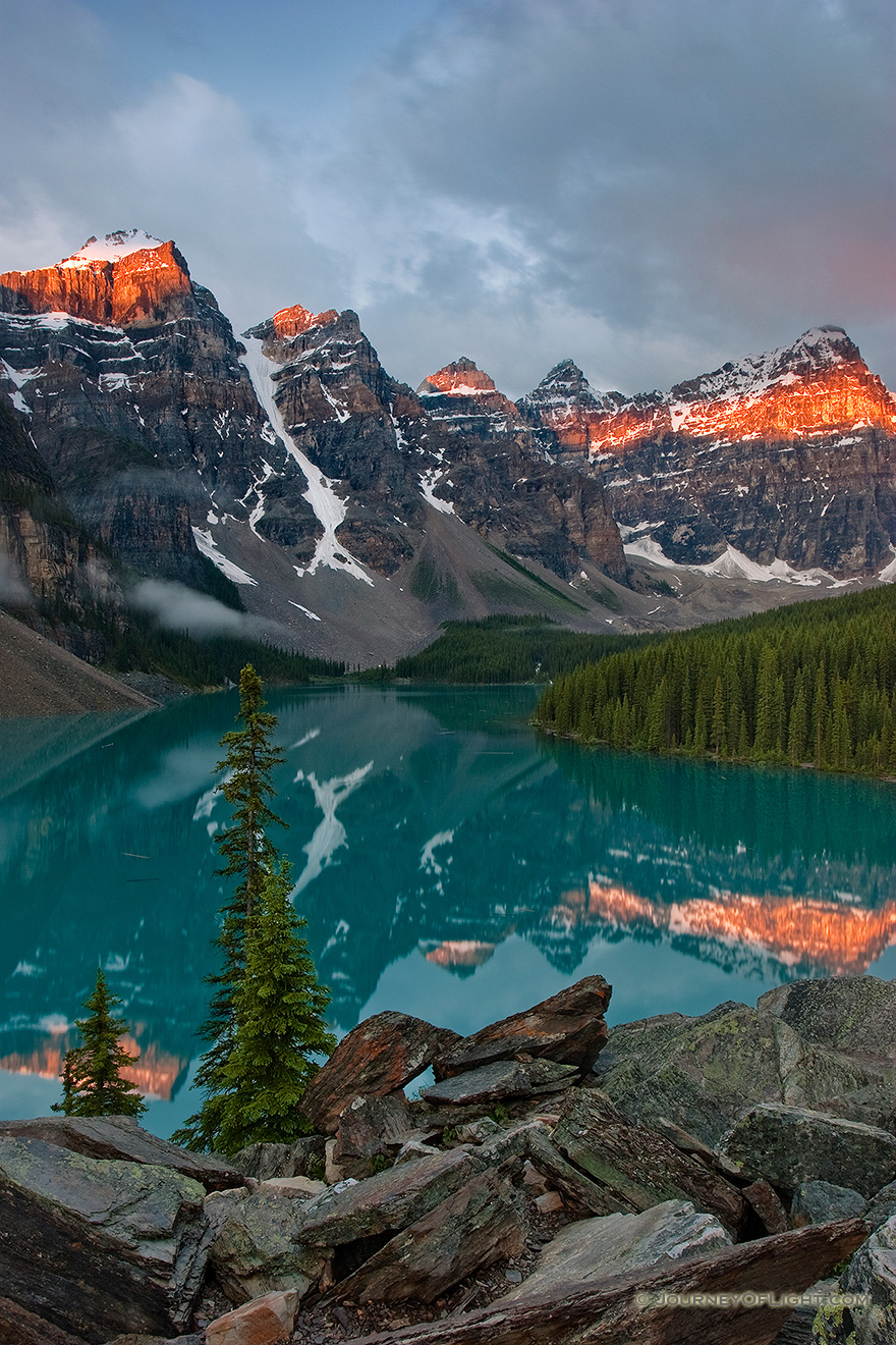 One of the most scenic and popular destinations in Banff National Park, Lake Moraine reflects the ten peaks on fire with an early morning glow.  Around 3:30 in the morning I rose to get to Lake Moraine for a 6:00 sunrise.  Since I was 60 miles away, I had to make sure to give myself enough time to get there and get set up.  This scene was my reward. - Banff Picture