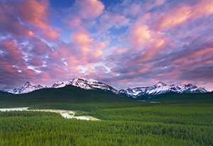 From a steep hill on the trail to Glacier Lake in Banff National Park, I could see the moon rise over the distant peaks. - Canada Photograph