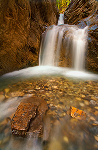 In the backcountry of the Kootenay Plains a hidden White Goat Falls cascades down a mountain side. - Rockies Photograph