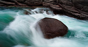 A lone rock holds against the rush of the water at Maligne Canyon in Banff National Park, Alberta, Canada. - Canada Photograph