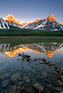 As the first light hits Mt. Cephron as mist rises from Upper Waterfowl Lake. - Canada Photograph