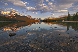 Clouds float lazily down the water as the last light hits at Maligne Lake located in Jasper National Park. - Canada Photograph