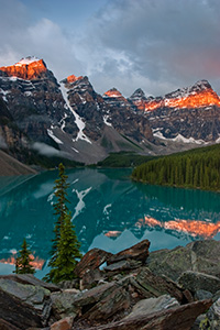 One of the most scenic and popular destinations in Banff National Park, Lake Moraine reflects the ten peaks on fire with an early morning glow.  Around 3:30 in the morning I rose to get to Lake Moraine for a 6:00 sunrise.  Since I was 60 miles away, I had to make sure to give myself enough time to get there and get set up.  This scene was my reward. - Canada Photograph