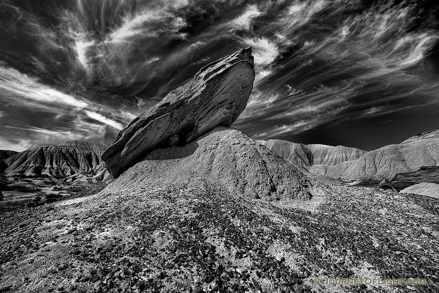 Wispy clouds float above a toadstool at Toadstool Geologic Park in Western Nebraska. - Toadstool Geologic Park Photography