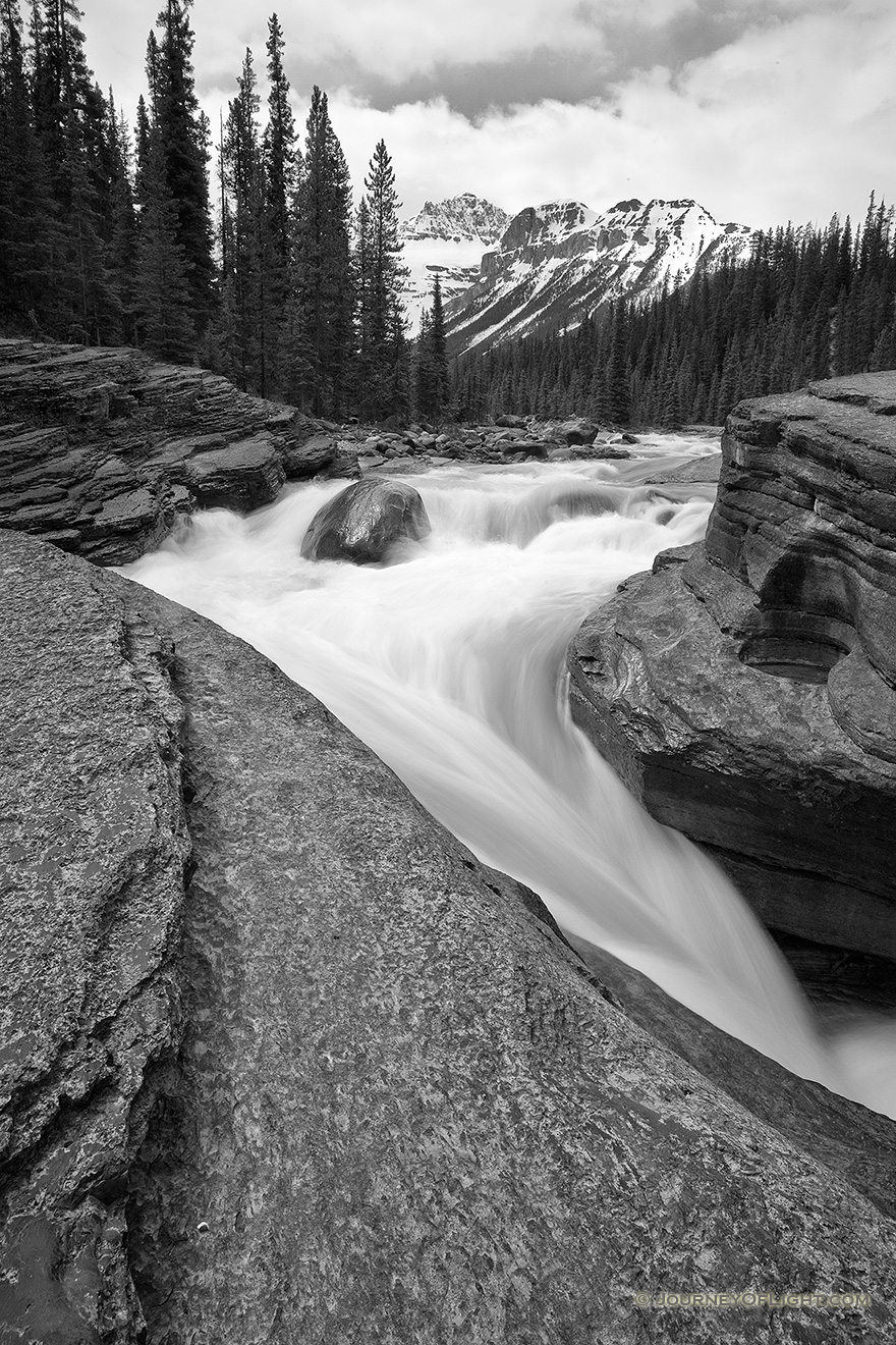 Water runs fast through Mistaya Canyon in the spring during the snow melt. - Canada Picture
