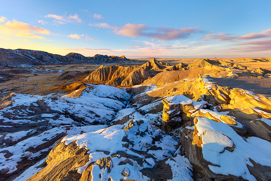 Scenic landscape photograph of sunset at Toadstool Geologic Park in western Nebraska after snow. - Nebraska Photography