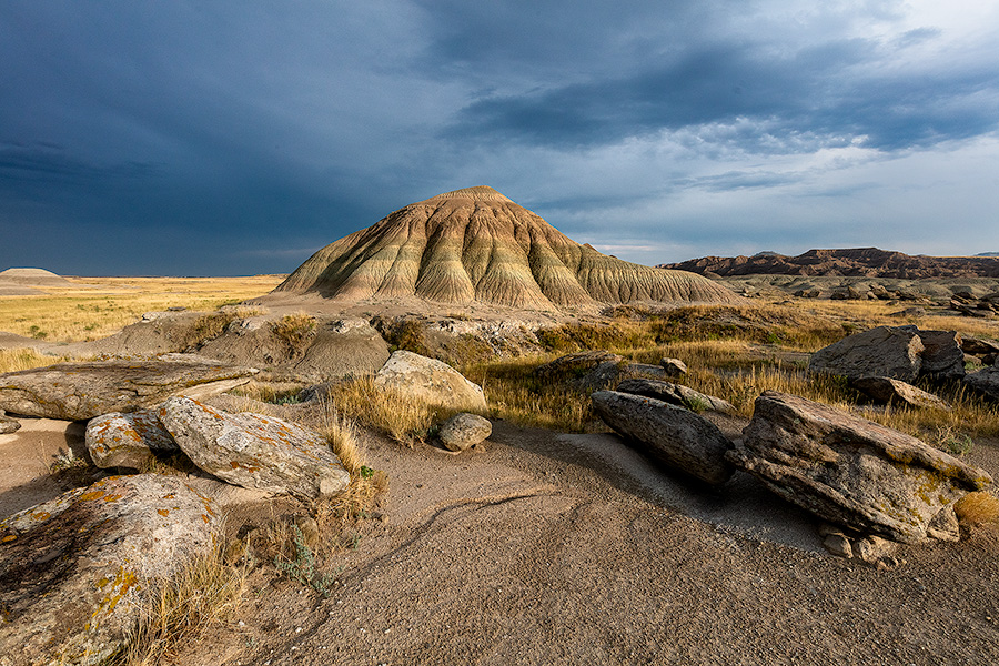 A scenic landscape photograph of Toadstool Geologic Park in western Nebraska under dark skies. - Nebraska Photography