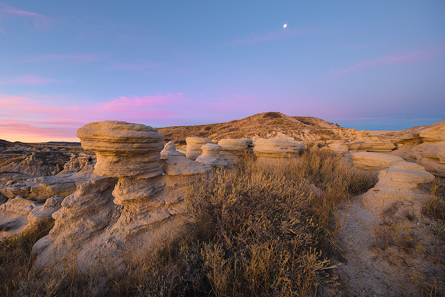 Scenic landscape photograph of a moonset over Toadstool Geologic Park in western Nebraska. - Nebraska Photography