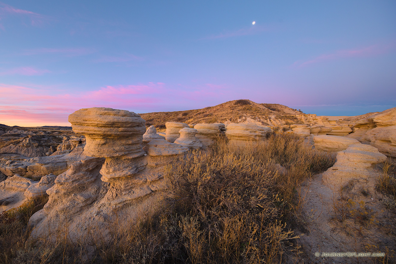 Scenic landscape photograph of a moonset over Toadstool Geologic Park in western Nebraska. - Nebraska Picture