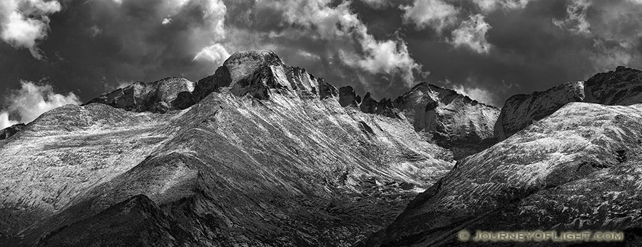 fter a fresh covering of snow, Long's Peak emerges from the clouds after a storm over Rocky Mountain National Park.