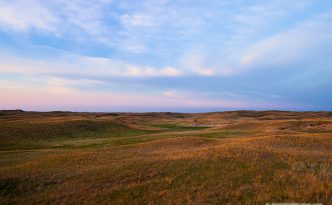 The last light of Day illuminates a windmill nesteld in the sandhills on the western edge of Halsey National Forest.