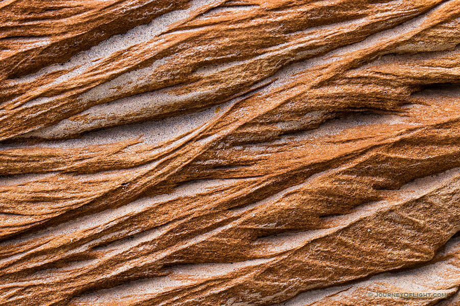 An abstract pattern caused by erosion in rocks embedded in the bluffs in Theodore Roosevelt National Park. - See more at: http://www.journeyoflight.com/photo/patterns-in-the-rock/north,dakota