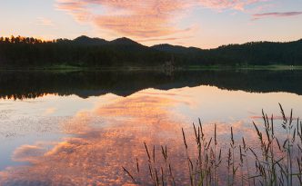 Stockade Lake in the Black Hills of South Dakota reflects the warmth of the rising sun.