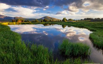 An idyllic mountain scene on the tundra of Rocky Mountain National Park. A small tarn reflects the beautiful sky and the mountains in the distance. - See more at: http://www.journeyoflight.com/photo/idillyc-tarn/colorado/60/63/1