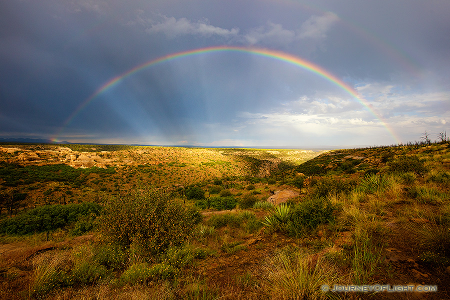 After an intense day of rain a beautiful rainbow appears over a canyon in the west area of Mesa Verde National Park.