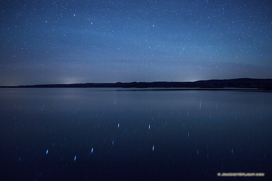 On a clear night at Niobrara State Park the stars shone brightly above the Missouri River. In the reflection of the river the Big Dipper can be clearly seen.
