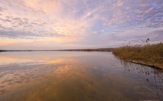 A beautiful sunset is reflected in the waters of the Missouri River at Niobrara State Park on the border of Nebraska and South Dakota.