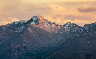 Long's Peak's western face glows with the last warm hues of sunset.