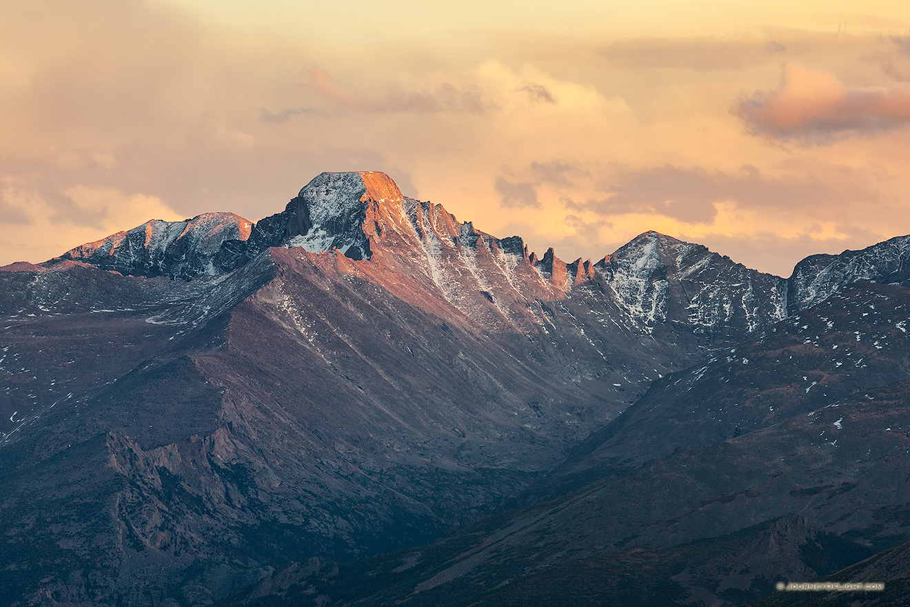 Long's Peak's western face glows with the last warm hues of sunset.