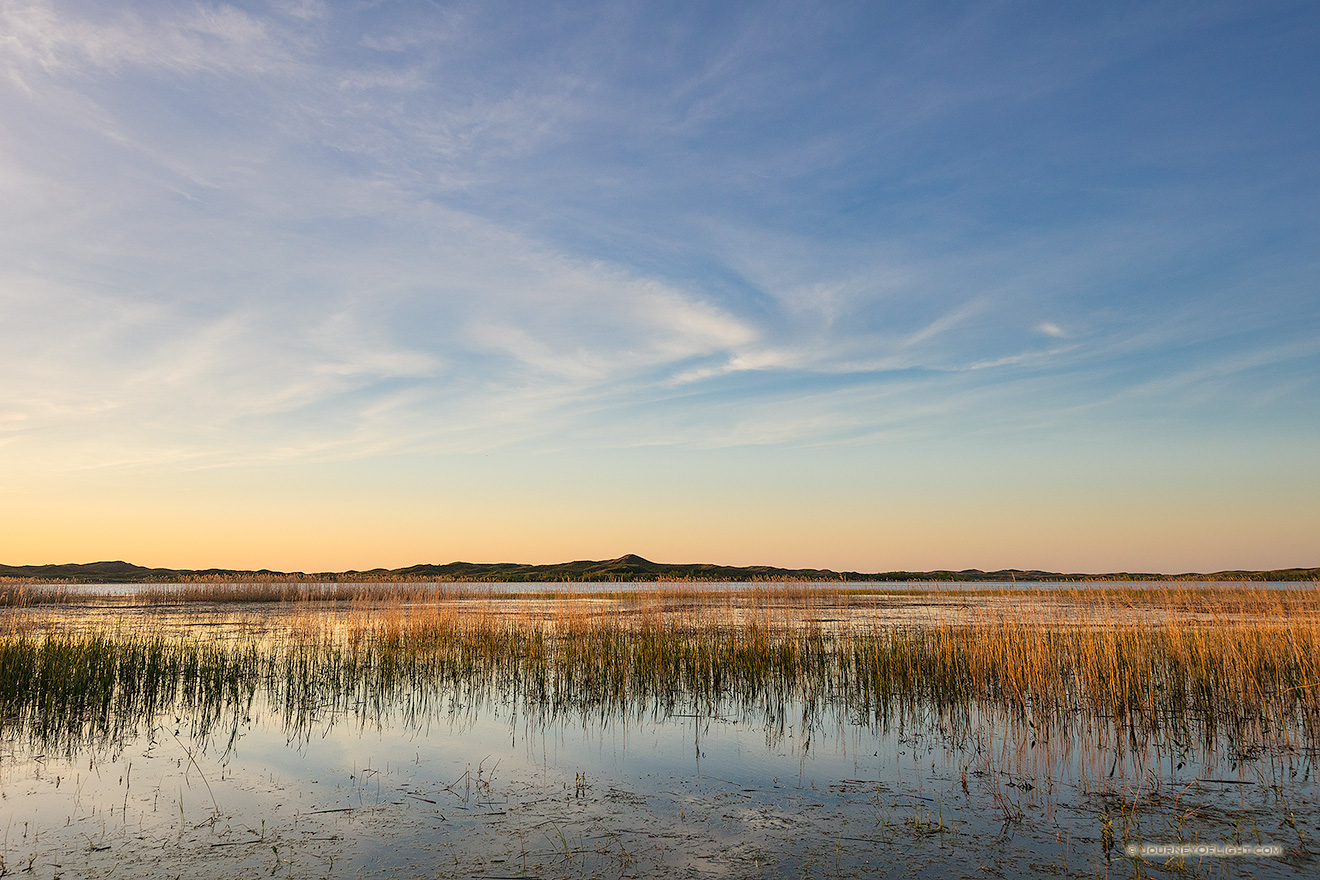 On a cool spring evening, sunset falls over Willow Lake nestled deep in the Sandhills of Nebraska.