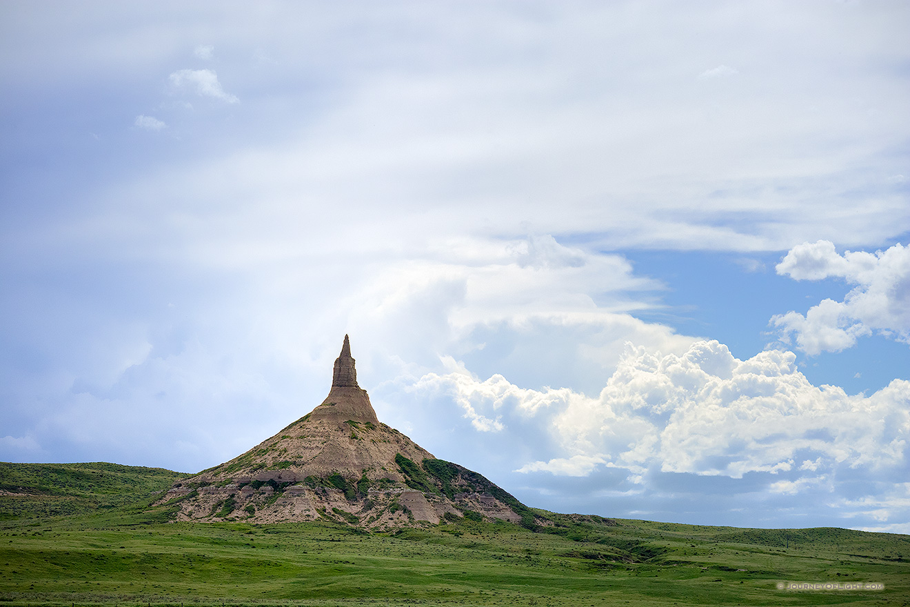 Afternoon storm clouds gather in the west billowing above Chimney Rock in the panhandle of Nebraska.