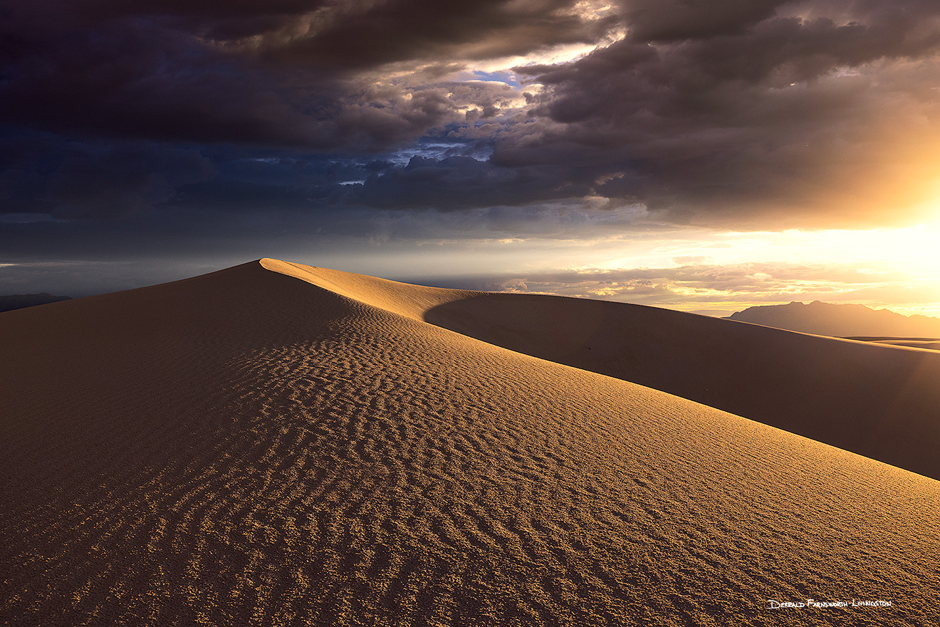 The setting sun illuminates sand dunes deep in White Sands National Park in New Mexico.